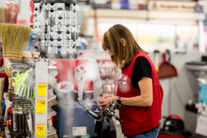 Moore Lumber Ace Hardware employee cutting a key on the key duplication machine in store