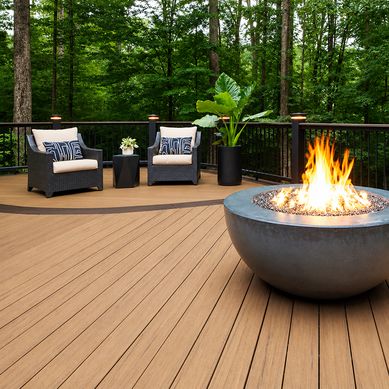 Composite deck with fire pit, wicker chairs, and dark railing surrounded by trees