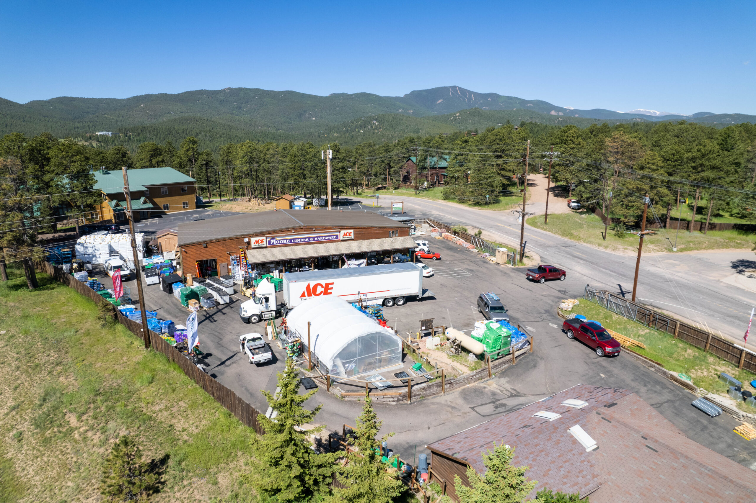 Aerial view of Moore Lumber Ace Hardware store with delivery truck and Colorado mountains
